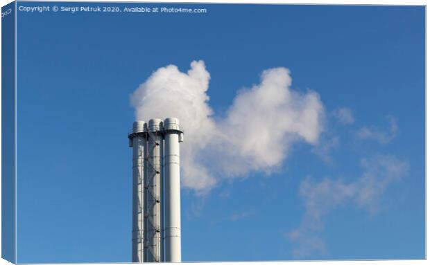 White smoke comes from a white chimney pipe on a background of blue sky. Canvas Print by Sergii Petruk