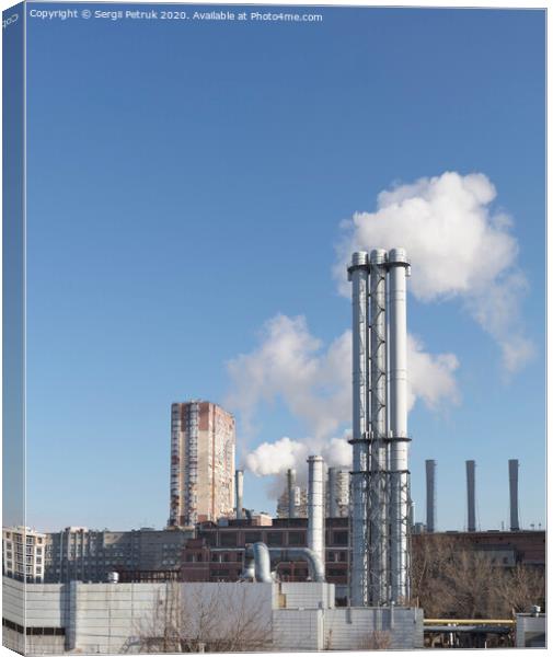 White smoke comes from a white chimney heat station pipe on a blue sky background. Canvas Print by Sergii Petruk