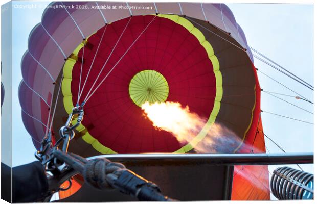 The flame of a gas burner inflates a balloon Canvas Print by Sergii Petruk