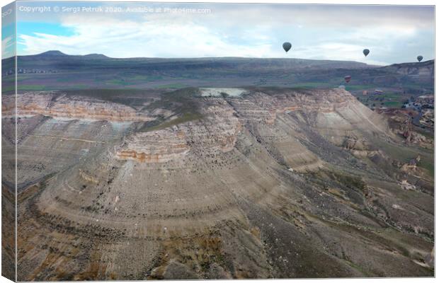 Balloons fly over the valleys in Cappadocia Canvas Print by Sergii Petruk