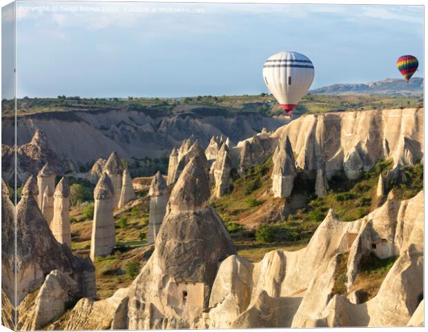 A balloon is flying over the valley in Cappadocia Canvas Print by Sergii Petruk