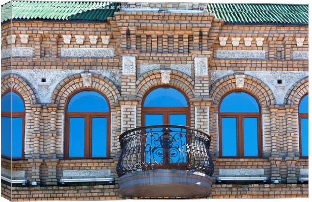 The wooden windows of the old architecture building reflect the blue clear sky Canvas Print by Sergii Petruk