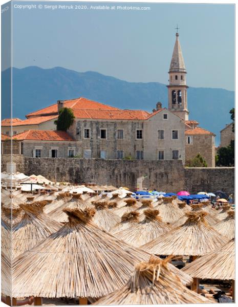 Thatched roofs of beach umbrellas in the bright sun Canvas Print by Sergii Petruk