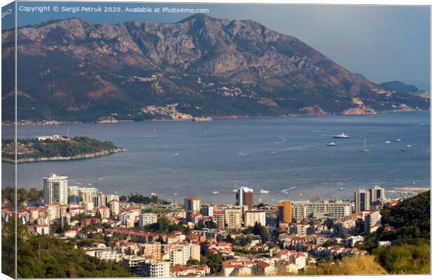 View of the modern city of Budva Riviera on the background of a sea bay and a mountain chain Canvas Print by Sergii Petruk