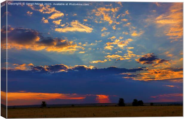 Fiery reddish sunset over a field in a rural evening landscape Canvas Print by Sergii Petruk