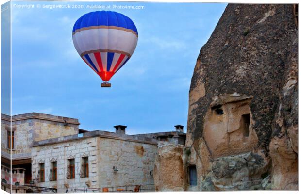 Balloon flying over the old town of Cappadocia Canvas Print by Sergii Petruk