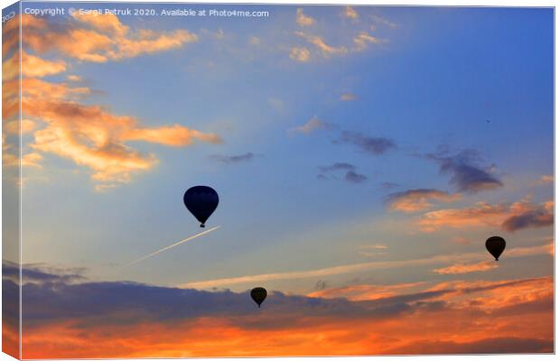 Silhouettes of balloons on the background of the morning sky with fiery red clouds. Canvas Print by Sergii Petruk