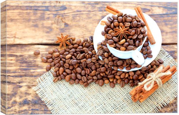 Grain coffee in a cup on a wooden background. Cinnamon on a napkin and tied with string. Anise stars complement the aroma of coffee. Canvas Print by Sergii Petruk
