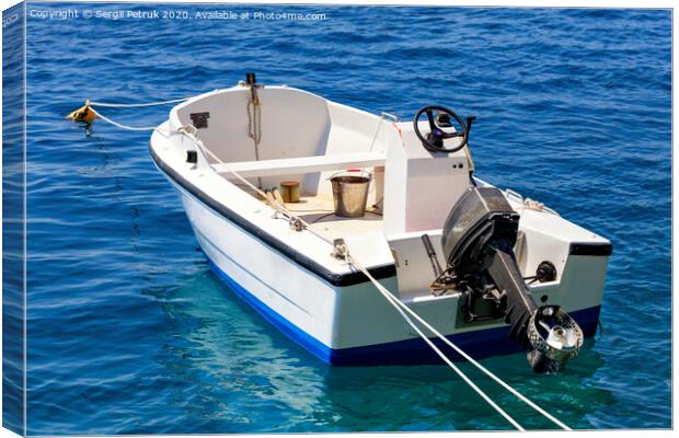 A motor boat is anchored in the clear waters of the Ionian Sea. Canvas Print by Sergii Petruk