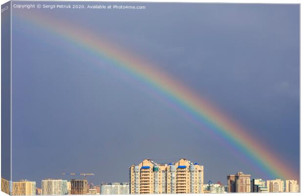 Rainbow in the sky above the city after a thunderstorm. Canvas Print by Sergii Petruk
