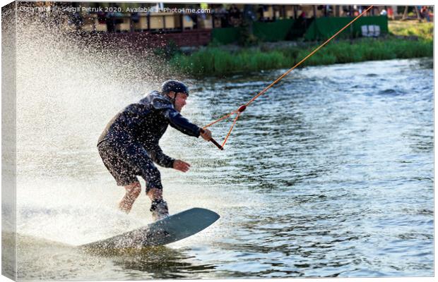 Wakeboarder rushes through the water at high speed along the grassy banks of the river. Canvas Print by Sergii Petruk