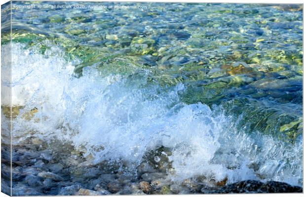 A splash of pure turquoise sea wave on pebble on the seashore. Canvas Print by Sergii Petruk