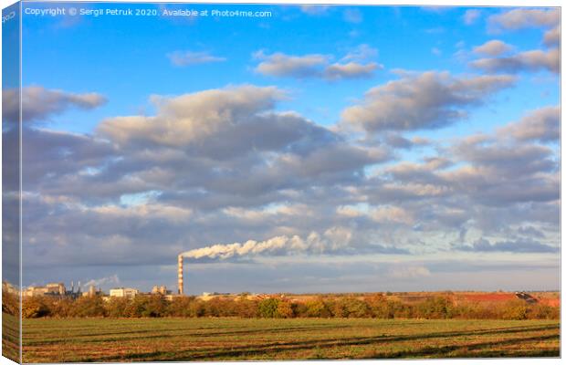 Rural autumn landscape, bright morning sunshine illuminate the agricultural field, the production complex on the horizon and a high cloudy sky. Canvas Print by Sergii Petruk