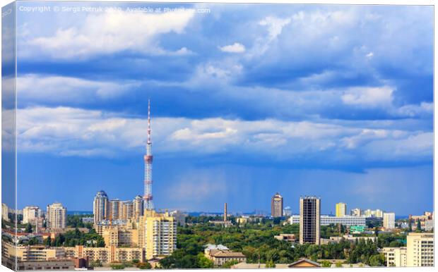 TV tower and residential areas of Kyiv at noon against the backdrop of a stormy blue summer sky. Canvas Print by Sergii Petruk