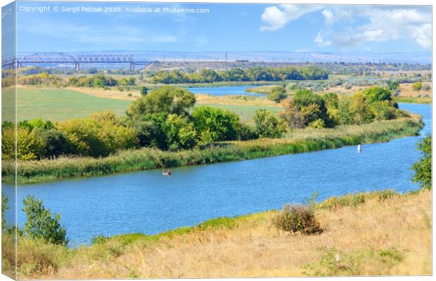 View of the Southern Bug River and the railway bridge on the horizon. Canvas Print by Sergii Petruk