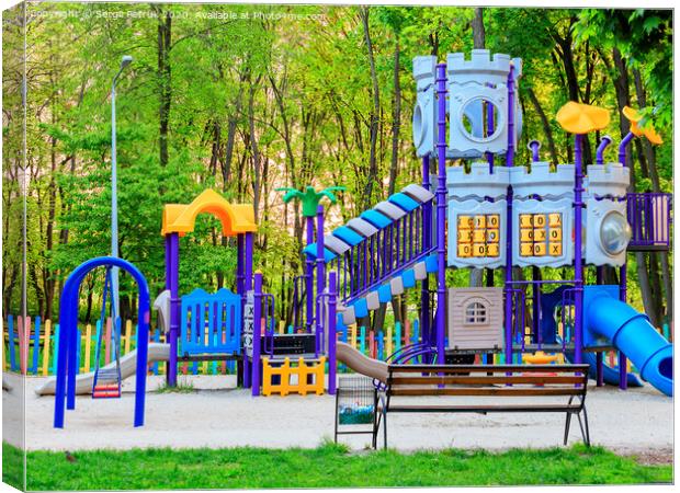 Bright children's colorful playground in the city summer park. Canvas Print by Sergii Petruk