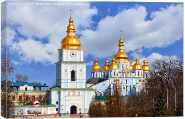 The famous Mikhailivsky Golden-Domed Cathedral and the bell tower in Kyiv in early spring against a blue cloudy sky. Canvas Print by Sergii Petruk