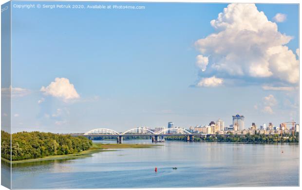 A large figured cloud hung over the city near the railway bridge near the Dnipro River. Canvas Print by Sergii Petruk