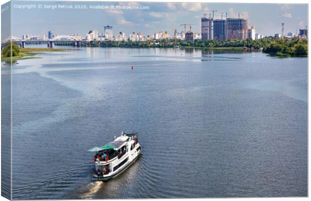 A river tram carries tourists along the Dnipro River along the left bank of Kyiv, top view. Canvas Print by Sergii Petruk