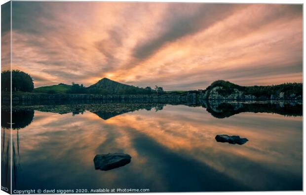 Cawfields Quarry rising sun fire Canvas Print by david siggens