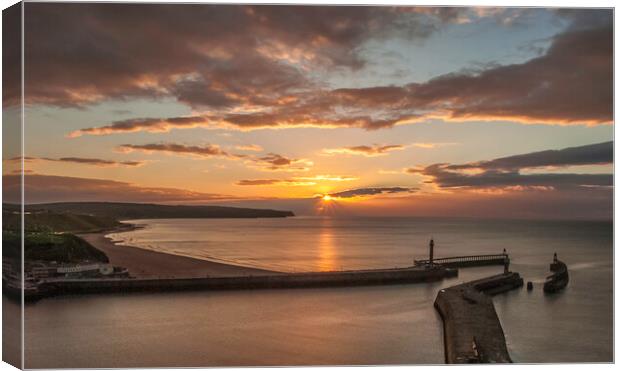 Sunset over Whitby piers Canvas Print by Andrew Sharpe