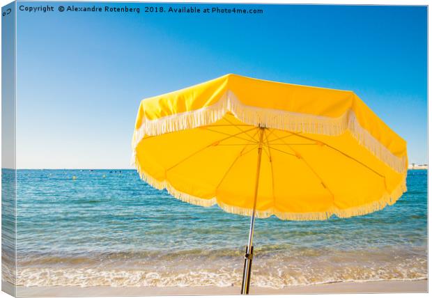Giant yellow beach umbrella next to the ocean agai Canvas Print by Alexandre Rotenberg