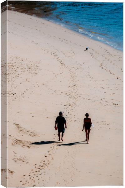 Man and woman walking on sandy beach  Canvas Print by Alexandre Rotenberg