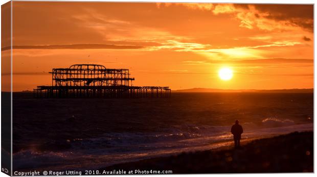 West pier sunset watcher Canvas Print by Roger Utting