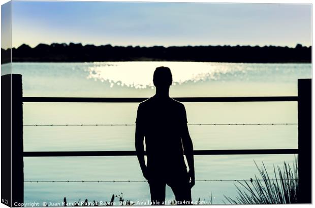 Silhouette guy standing  in the barbed wire fence Canvas Print by Juan Ramón Ramos Rivero