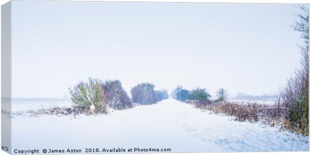 Looking down a Railway line in a Blizzard Canvas Print by James Aston