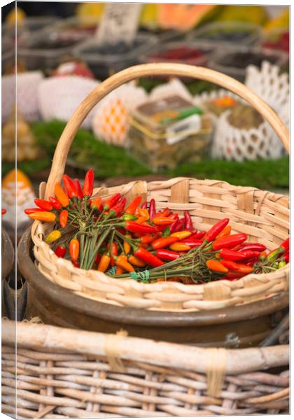 Red hot chillies in a basket Canvas Print by Andrew Michael