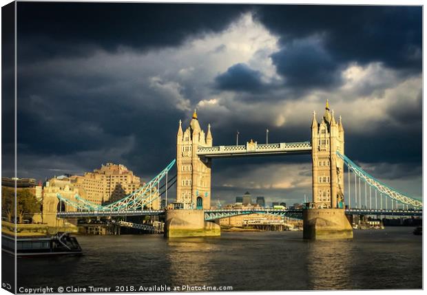 Tower bridge illuminated in a dark sky Canvas Print by Claire Turner