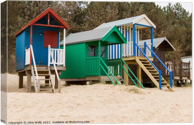 Colourful beach huts Canvas Print by Clive Wells