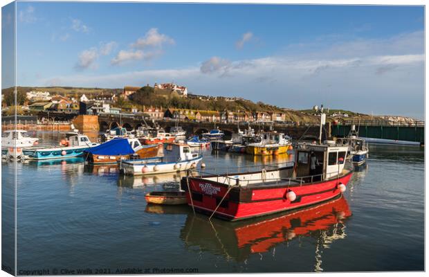 Fishing boats at high tide Canvas Print by Clive Wells