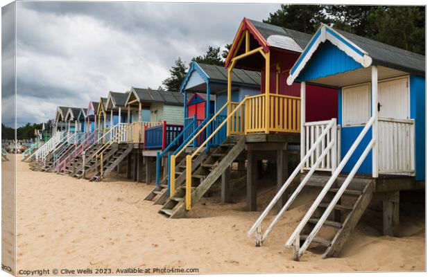 Colourful beach huts Canvas Print by Clive Wells