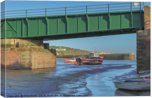 View under the railway bridge at Folkestone Harbou Canvas Print by Clive Wells