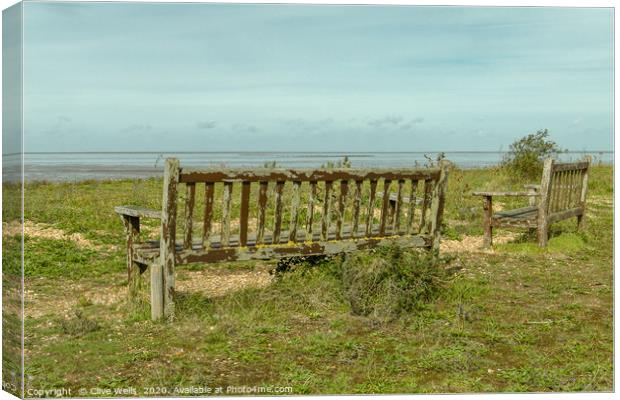 Wooden benches overlooking the Wash at Snettisham Canvas Print by Clive Wells
