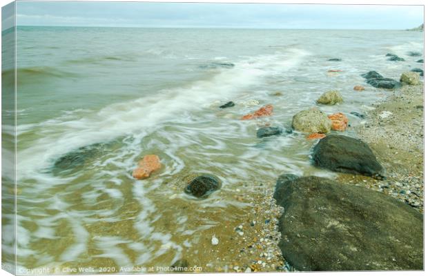 Swirles on the incoming tide at Hunstanton. Canvas Print by Clive Wells