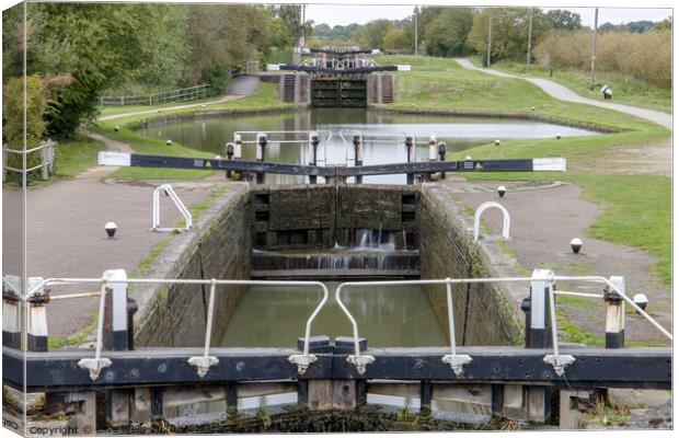 Row of lock gates at Stoke Bruene, Northamptonshir Canvas Print by Clive Wells
