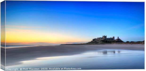 Sunrise over Bamburgh Castle No. 2 Canvas Print by Phill Thornton