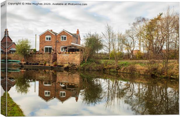 House on Canal side Canvas Print by Mike Hughes