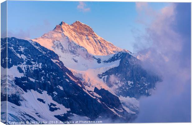 Evening light and mist on the Jungfrau Canvas Print by Jon Sparks