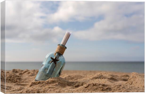 Message in a bottle on the sand Canvas Print by Anthony Hart