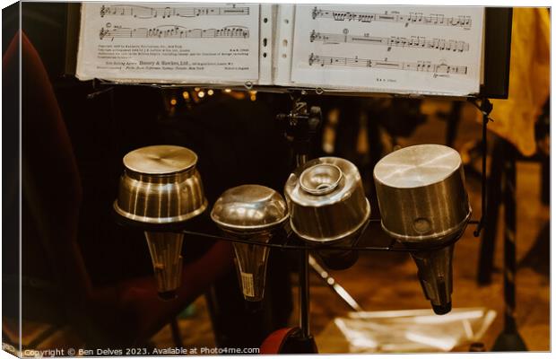 Trumpet mutes in a row with sheet music on a stand Canvas Print by Ben Delves