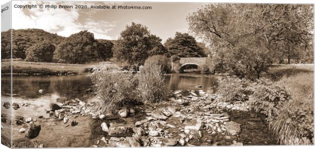 Welsh stream leading to an old bridge Canvas Print by Philip Brown