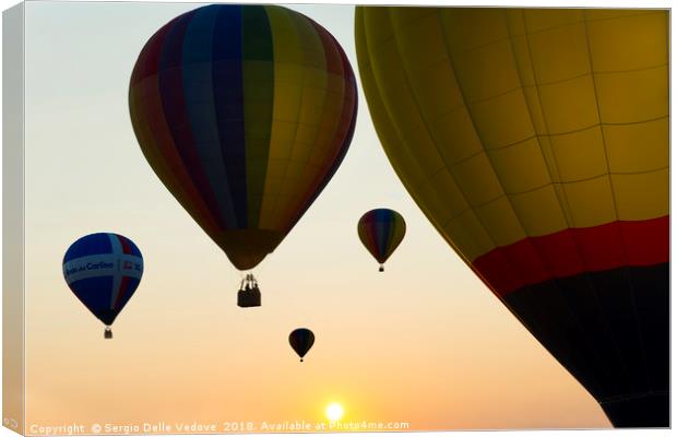 Balloons flying at the sunset Canvas Print by Sergio Delle Vedove