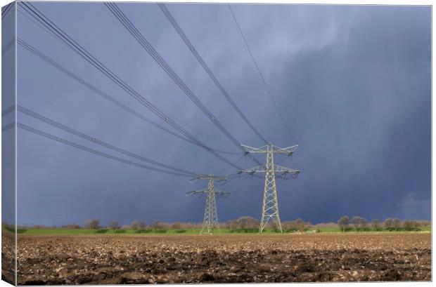 Power pylon in bad weather Canvas Print by John Stuij