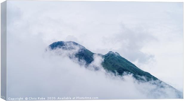 Arenal Volcano peaking through clouds Canvas Print by Chris Rabe