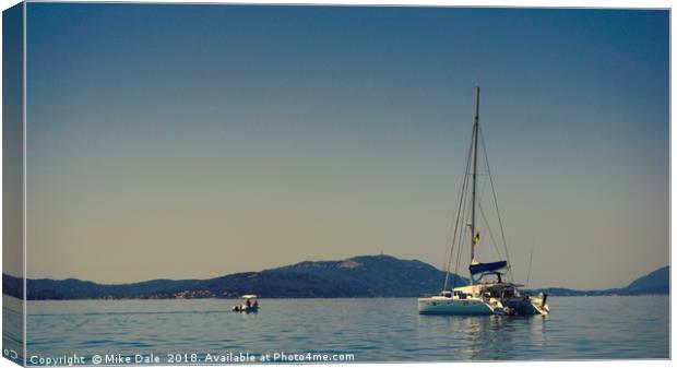                      A white yacht moored off Paxo Canvas Print by Mike Dale