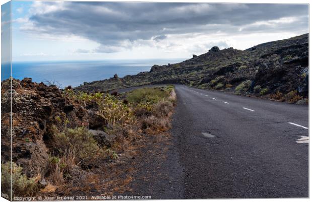Empty road in a volcanic landscape in the Island of La Palma Canvas Print by Juan Jimenez